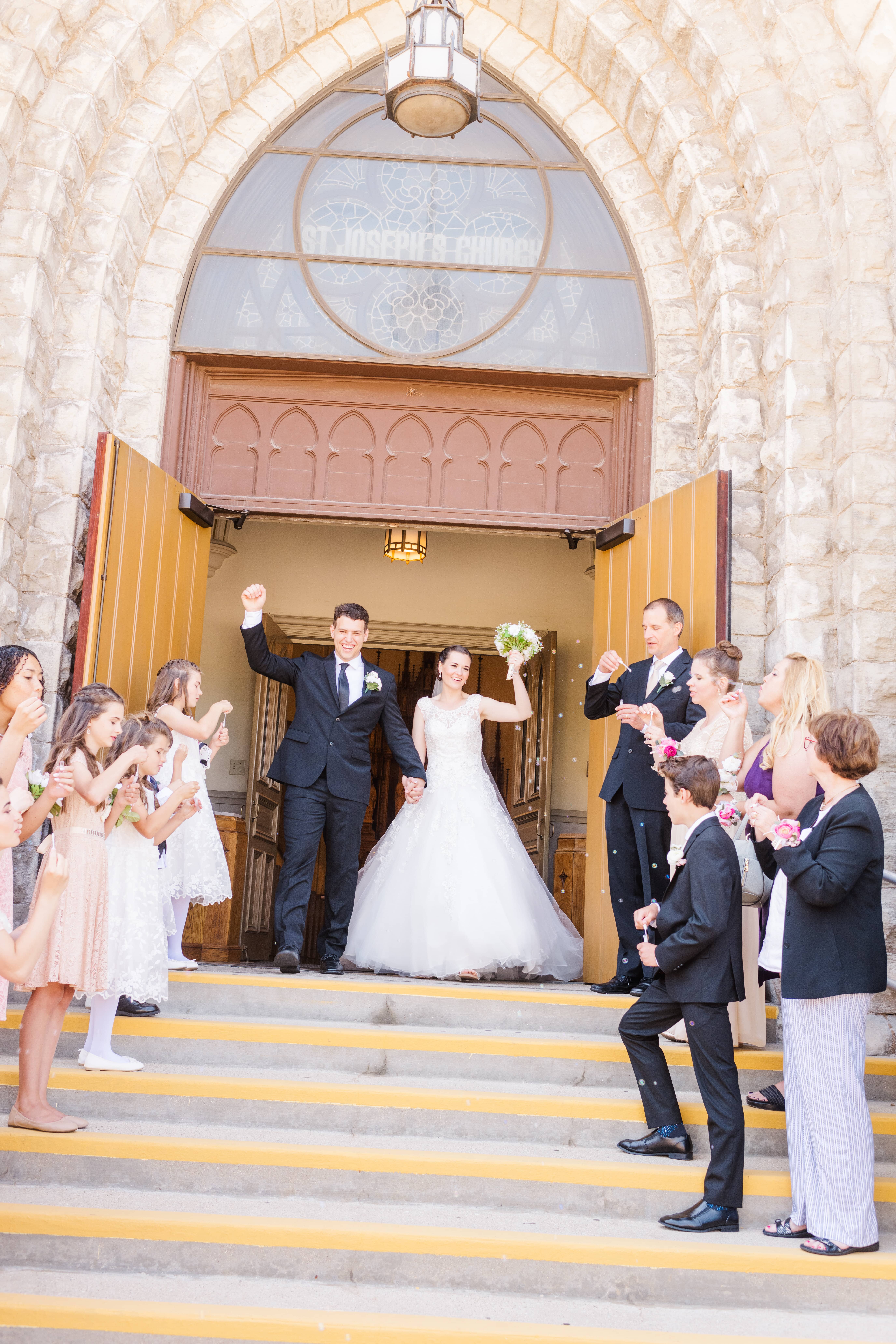 Catholic bride and groom exit church after wedding ceremony