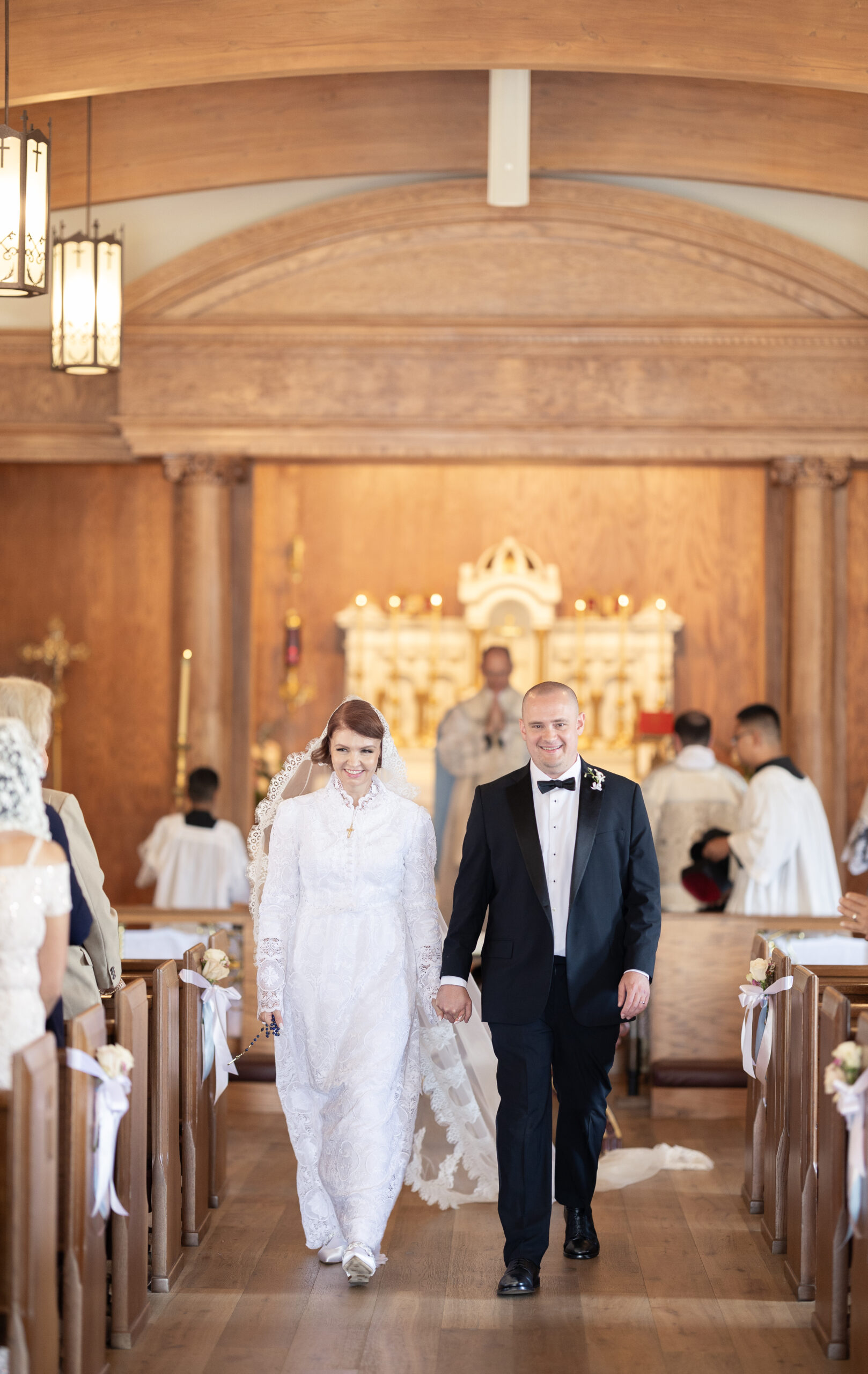 Los Angeles Catholic wedding photographer captures moment Catholic couple recesses up aisle after their Nuptial Mass